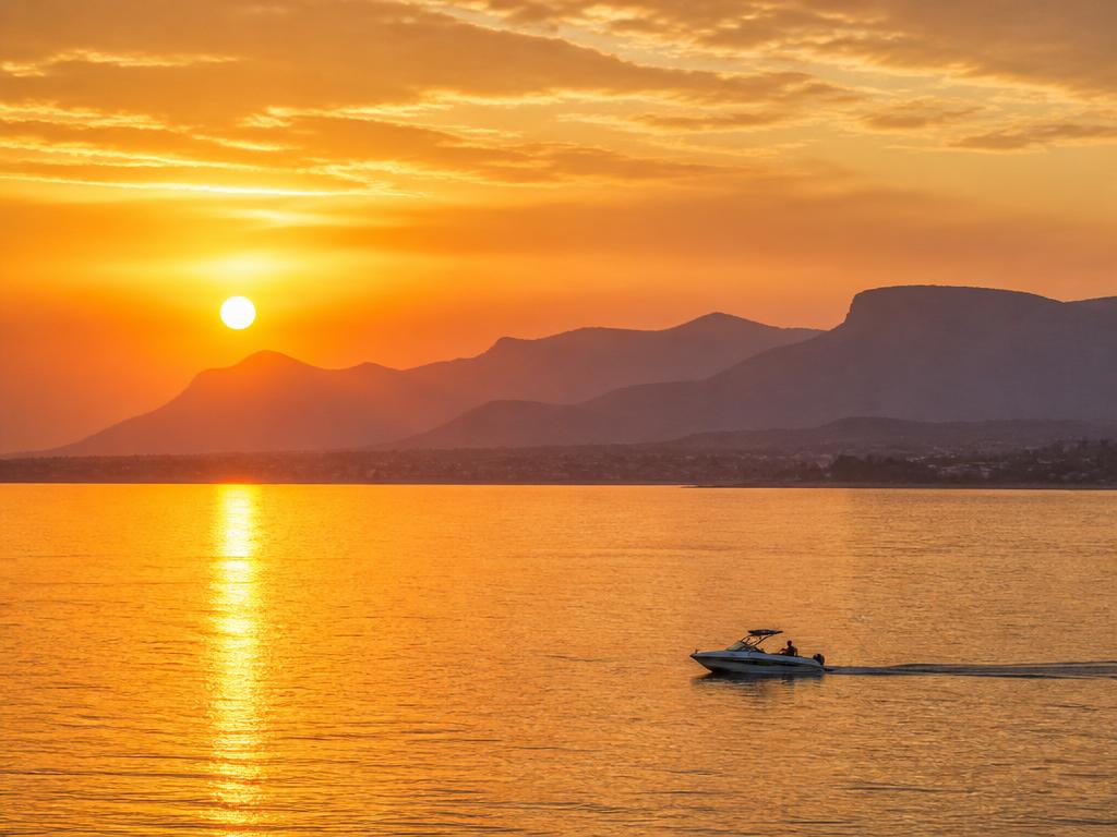 Sunset cruise on Hartbeespoort Dam with mountain silhouette